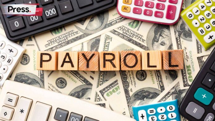 a series of wooden blocks that spell the word 'payroll'