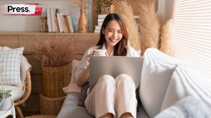 malaysian woman working from home on her sofa